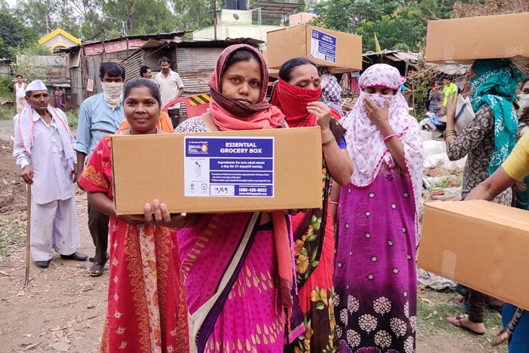 People receive essential grocery boxes in Pune
