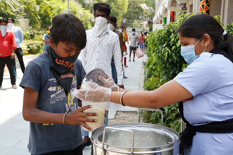 The Akshaya Patra volunteer distributing dry groceries to the needy in Ahmedabad