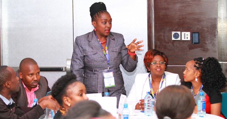 A delegate at the conference asks a question during the panel discussion