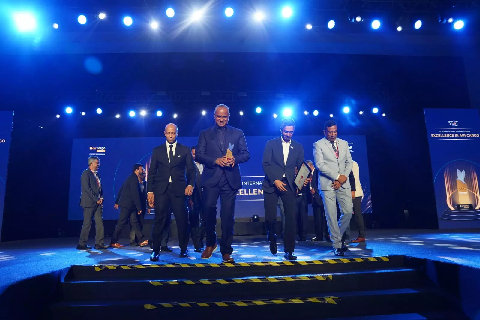 Sultan leaves the stage with the award flanked by Abdulla AlKhallafi, Cargo Manager, India & Nepal (left) and Khalid Bardan, VP Cargo Commercial, West Asia and Indian Ocean (right)