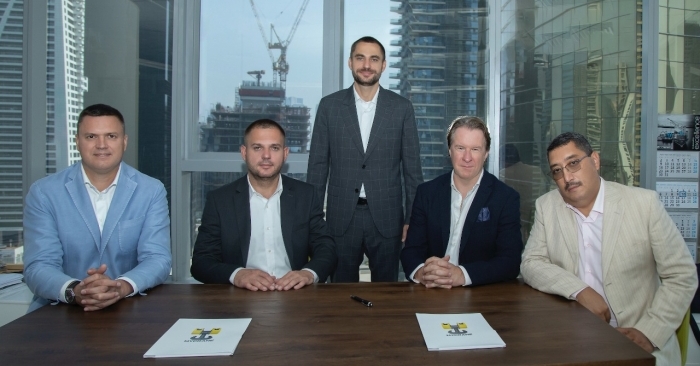 MYCRANE founder Andrei Geikalo, standing, is pictured with his new franchise partners following the signing of partnership agreements