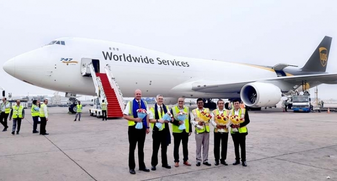 Boeing 747-8F freighter and its crew at IGIA.  Standing from left to right:  Craig Frederick Beauchamp, First Officer, Joseph Paul Racz, Captain, Rachid Fergati, UPS Managing Director for the Indian subcontinent, Shyam Sunder, Deputy CEO, DIAL, Sanjiv Edward, COO, DIAL and Vijay Sharma, Head Cargo, DIAL.